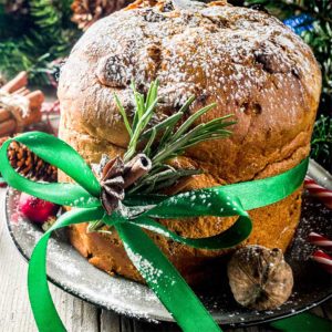 Panettone on a plate dusted with powdered sugar