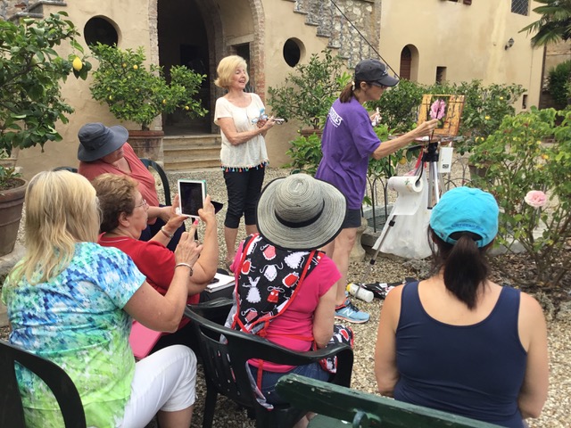 Pat demonstrates painting flowers in the garden on location in Tuscany.