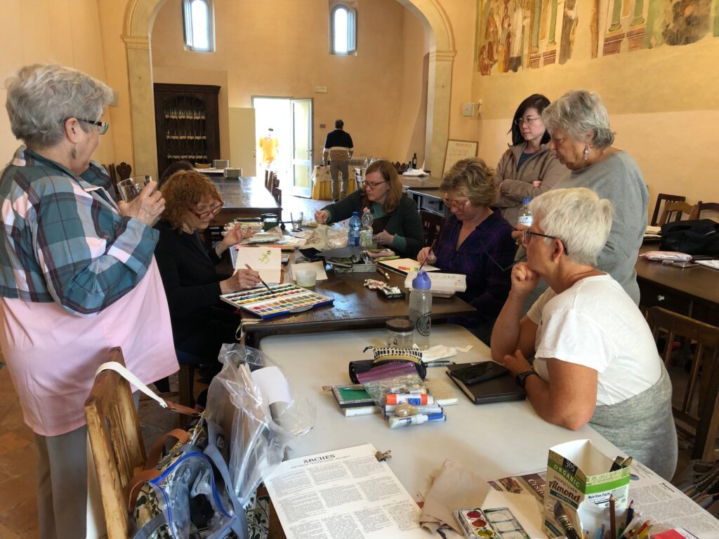 Sharon demonstrates a painting technique to students during her workshop at San Fedele this past October.